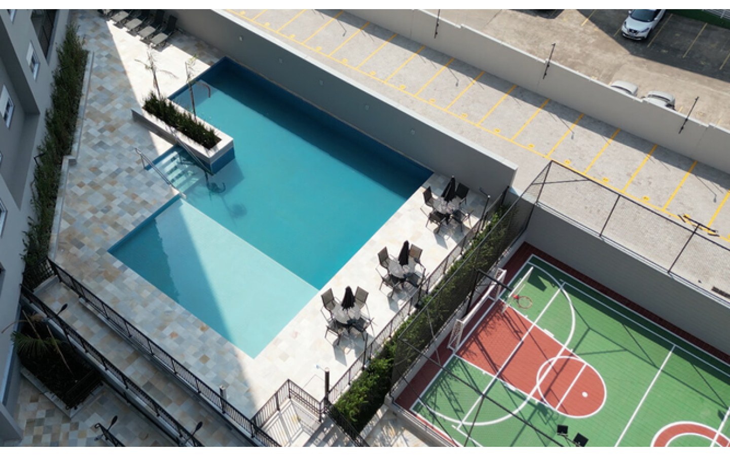 Foto real da piscina e da quadra entregues no Firenze Residencial